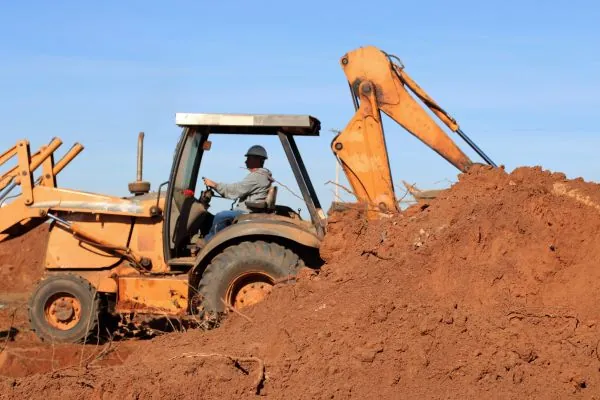 Man Using Backhoe Essential Tips for Yard Grading in South Shore, MA